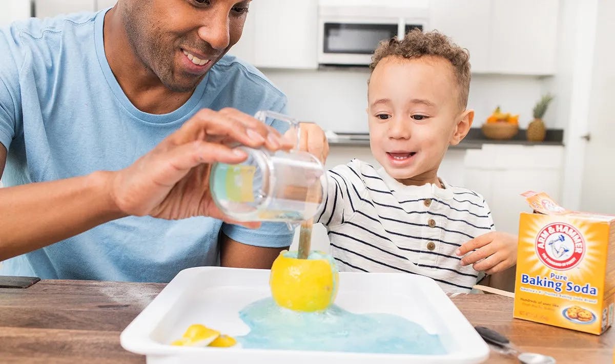 Child and father playing with the Liquid Lab from The Investigator Play Kit