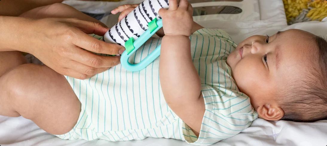 Child holding a Sensory Link from The Looker Play Kit