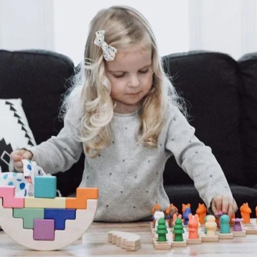 Child playing with toys from The Problem Solver Play Kit